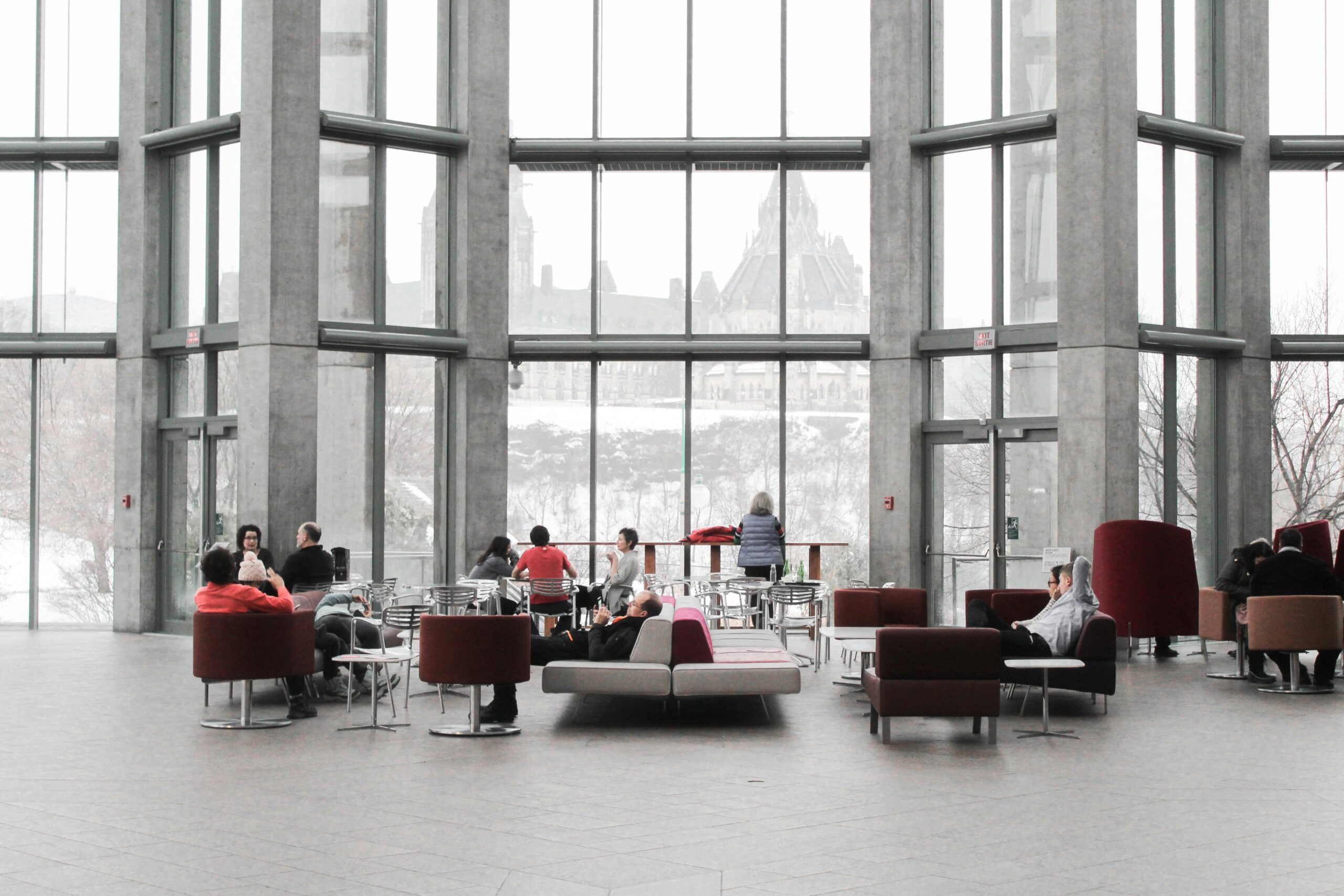 Spacious lounge with modern decor and large windows showcasing a snowy Ottawa view.